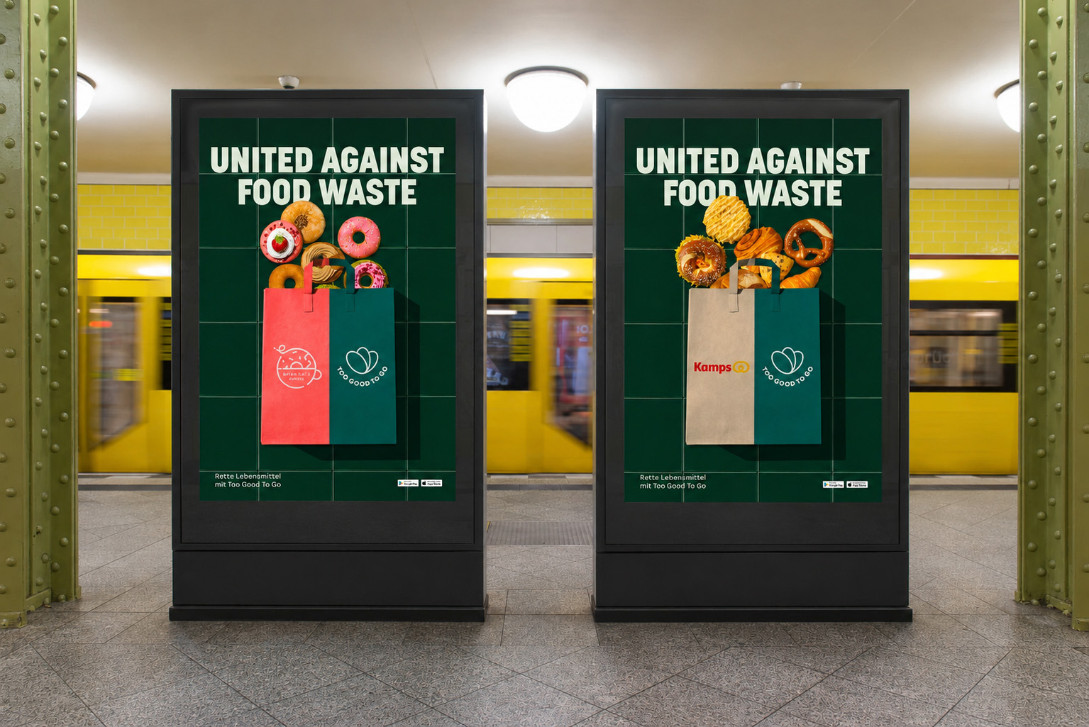 Two 'United Against Food Waste' totem posters on a subway platform, with Brammibal's Donuts and Kamps